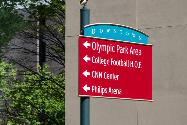 Road direction sign for Olympic Park Area College Football CNN center and Philips Area in Atlanta, Georgia Atlanta, USA - April 20, 2018: Road direction sign for Olympic Park Area College Football CNN center and Philips Area in downtown Georgia city street georgia football stock pictures, royalty-free photos & images