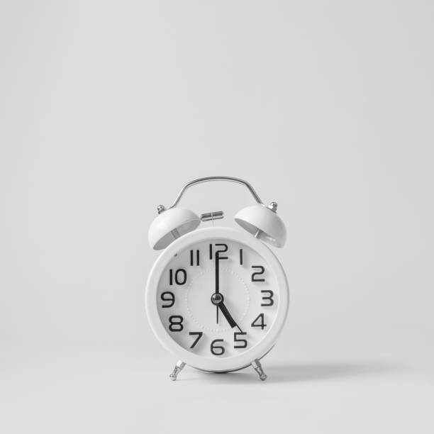 istock White vintage alarm clock on white background. 1154246472