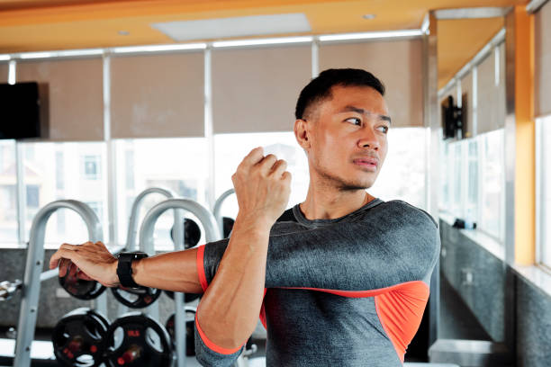 istock Sportsman stretching arms 1154249223