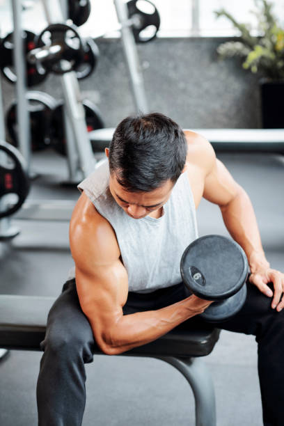 istock Fit man exercising with dumbbells 1154249282
