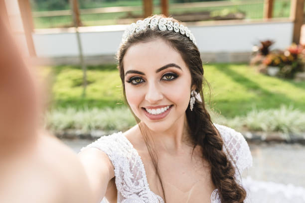 istock Beautiful bride taking a selfie outdoors before the wedding 1154251242