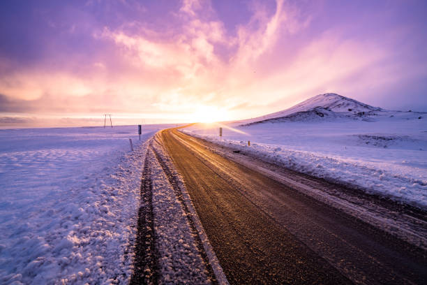 istock Winter sunset view on the road trip 1154254780