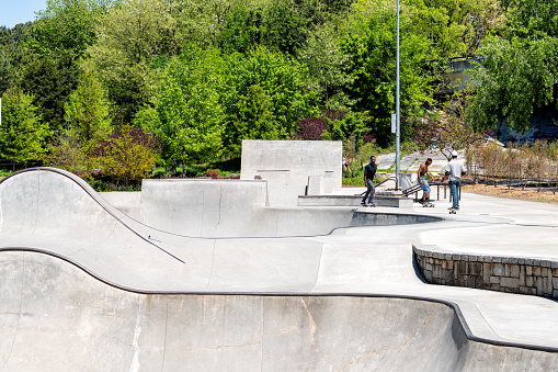 Atlanta, USA - April 20, 2018: Fourth Ward historic skatepark in Georgia downtown city with rink and people doing sports