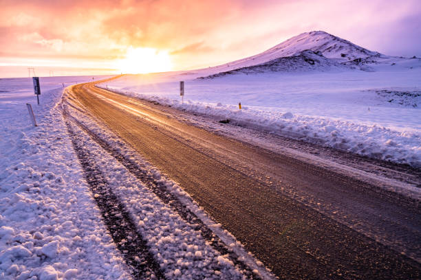 istock Winter sunset view on the road trip 1154254905