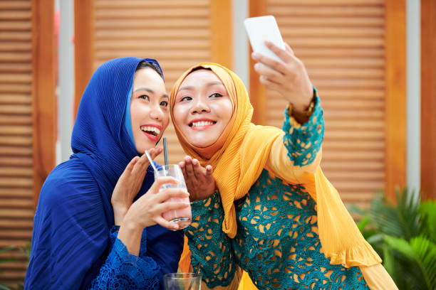 istock Young women in hijabs posing for selfie 1154258215
