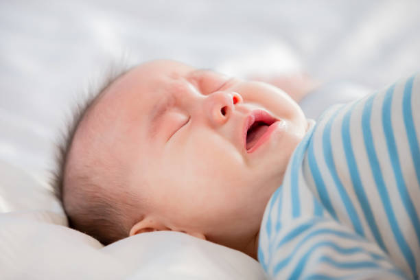 istock baby lying on the bed 1154267878