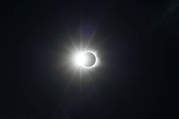 istock Total Solar Eclipse where the moon passes in front of the sun creating a diamond ring effect with faint clouds 1154269824