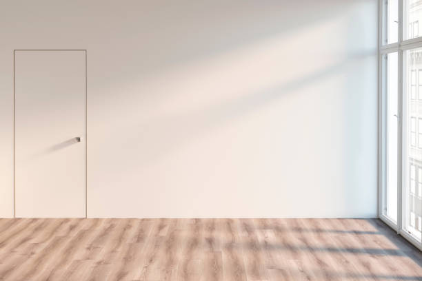 An empty room with door and window