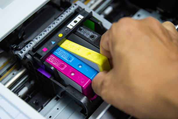 istock Technicians are installing the color printer inkjet cartridge 1154291174