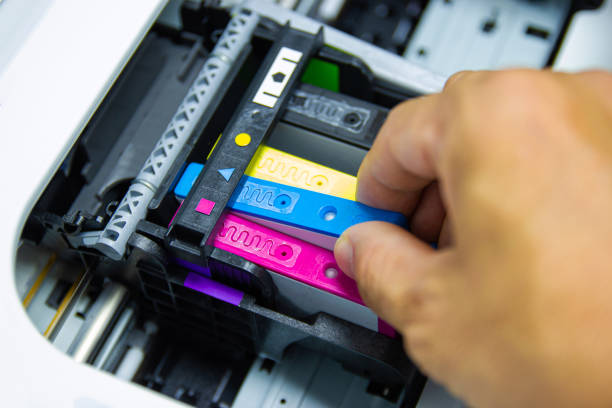 istock Technicians are installing the color printer inkjet cartridge 1154291249