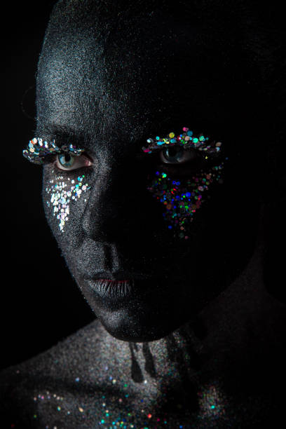 istock Girl in black makeup with sparkles 1154306321