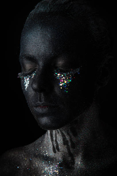 istock Girl in black makeup with sparkles 1154306356