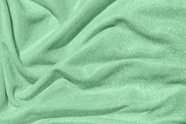 istock Trendy mint colored Background of draped fabric with silver lurex thread 1154313081