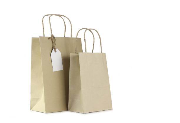 istock Brown shopping bags and blank tag isolated on white 1154315709