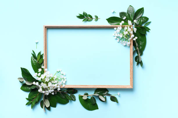 istock Creative layout with white flowers and copyspace over blue background. Top view, flat lay. Spring and summer concept. 1154317017