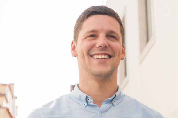 istock Happy cheerful Caucasian guy walking around city 1154318664