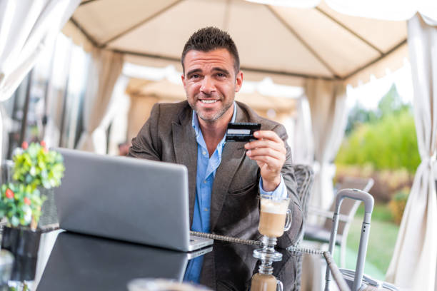 istock Modern businessman using laptop and credit card 1154320769