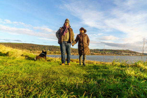 istock Senior couple walking on countryside path in winter 1154320945