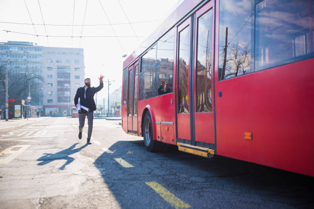 istock Businessman trying to catch the bus 1154322835