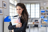 Worried businesswoman holding documents at workplace