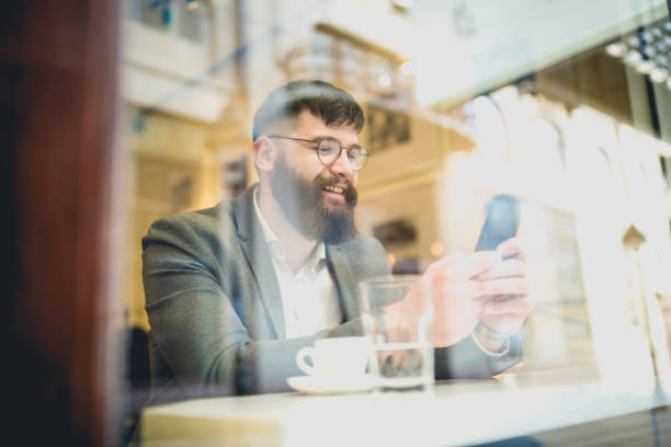 istock Hipster businessman working in cafe on coffee break 1154322926
