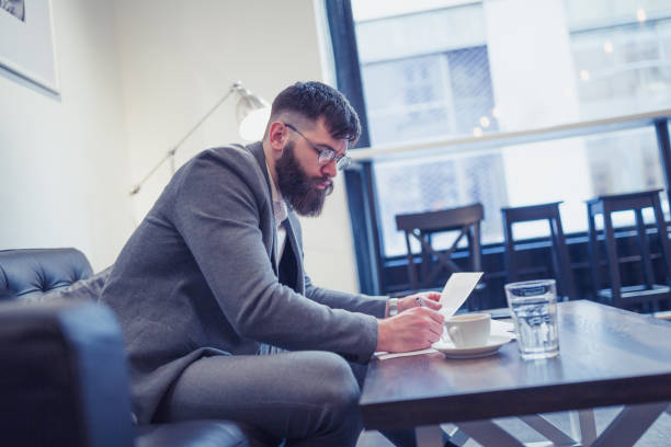 istock Hipster businessman working in cafe on coffee break 1154322967