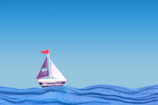 istock Toy iron ship on the fabric waves. Summer background 1154323038