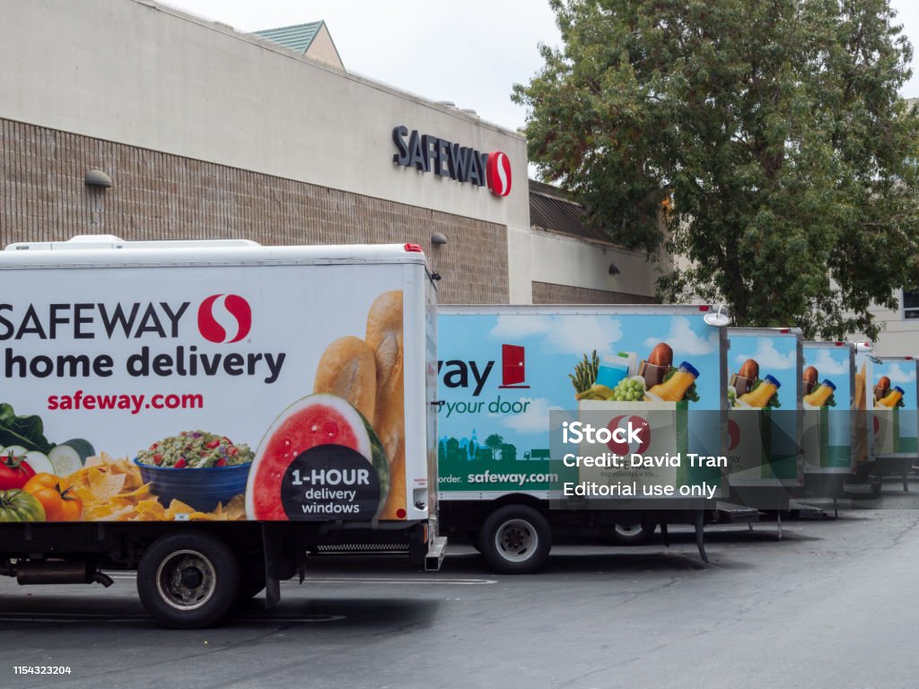 Fleet of Safeway home grocery delivery trucks outside of store location San Francisco, CA JULY 29, 2018: Fleet of Safeway home grocery delivery trucks outside of store location Truck Stock Photo