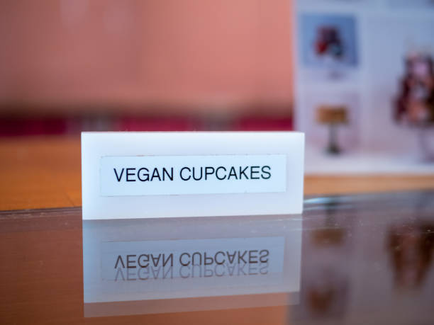 istock Vegan cupcakes sign sitting on table on counter atvegan bakery 1154323265