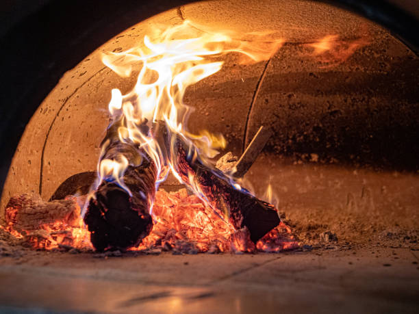 istock Flames, logs, ashes, embers inside wood burning pizza oven 1154324159