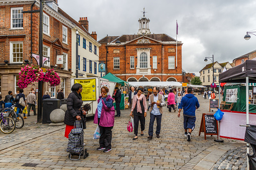 High Wycombe, England - 14th August 2015:  Market day on HIgh Street looking towards the Guildhall. The market is held every Tuesday, Friday and Saturday.