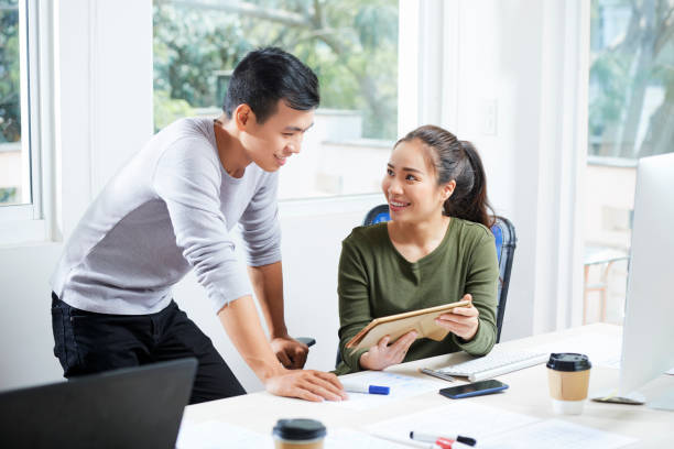 istock UX designer showing project to coworker 1154326409
