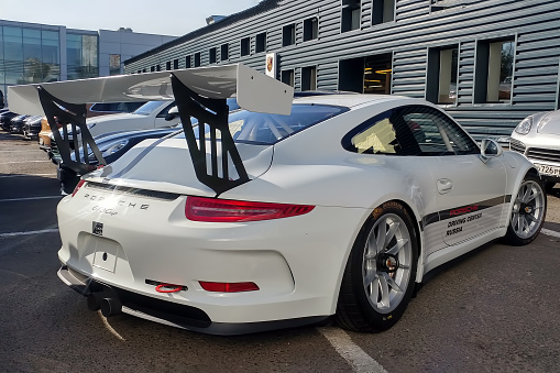 Moscow, Russia - May 05, 2019: White Porsche 911 GT3 RS Cup parked on the street. Super tuned and full modified racing car. Right side of car and giant aero spoiler