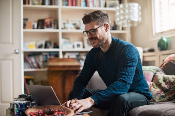 istock Young man freelancer working from home and using laptop. 1154328858