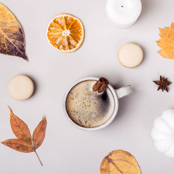 istock Coffee with cinnamon and autumn leaves on gray background. Autumn creative composition 1154332450