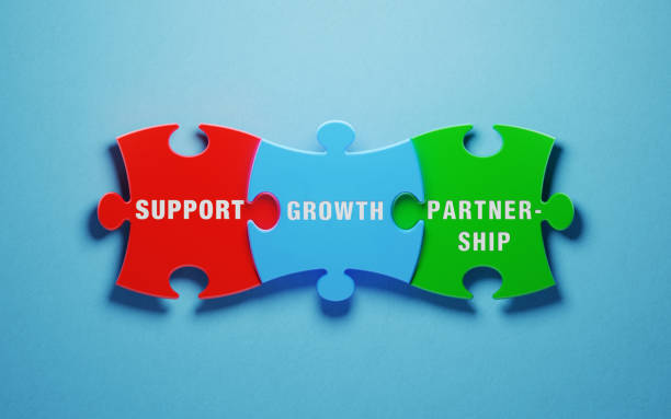 istock Partnership Concept - Colorful Jigsaw Puzzle Pieces On Blue Background 1154333580