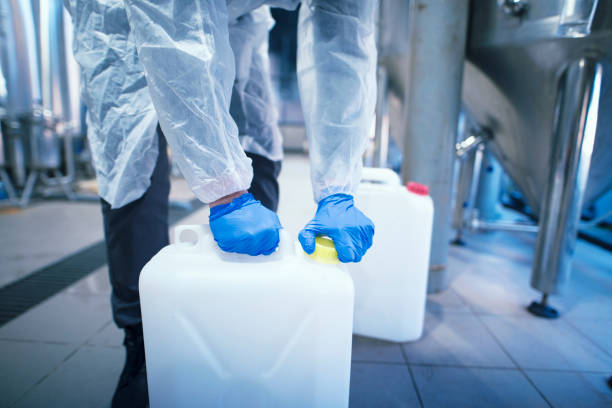 istock Shot of an unrecognizable industrial worker technologist with protective rubber gloves opening plastic can with chemicals in factory. 1154333799