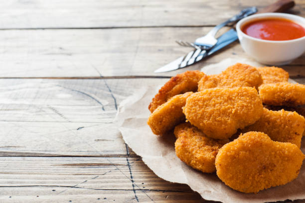 istock chicken nuggets with tomato sauce on wooden background. Copy space. 1154336738