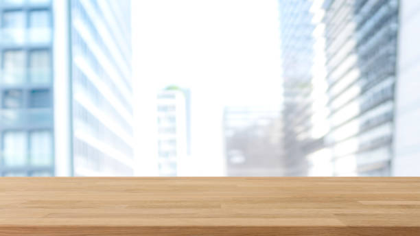 istock Empty wood table top and blur glass window wall building banner mock up background - can used for display or montage your products. 1154336847
