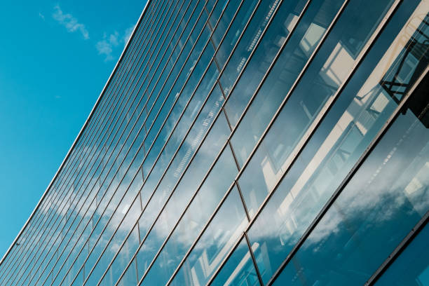 istock glass facade of modern office building and blue sky - 1154336923