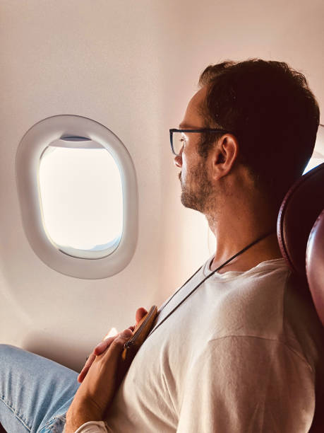 istock Airplane passenger with a neck bag for safe carrying money and documents. 1154337360