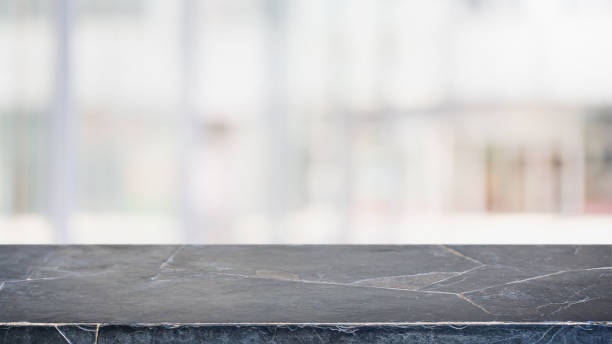 istock Empty black marble stone table top and blurred bokeh cafe and restaurent interior background with vintage filter - can used for display or montage your products. 1154338706