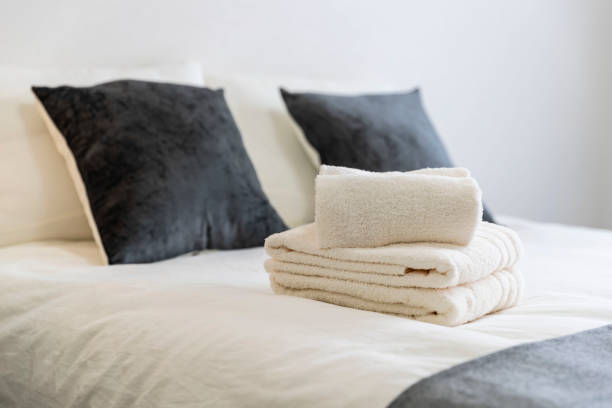 istock Clean white towels placed on the bed 1154339355