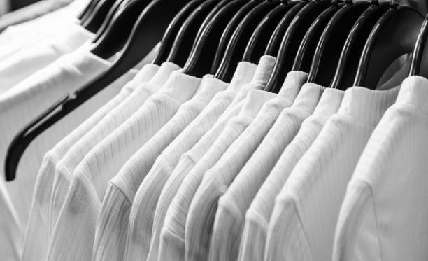 istock hangers in white t shirt cloth display background 1154341884