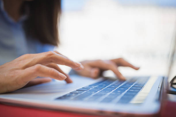 istock Young businesswomen enjoying coffee break at cafe, using laptop 1154343155