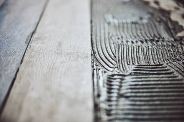 istock Leveling ceramic tiles on a floor. Shallow depth of field. 1154347575