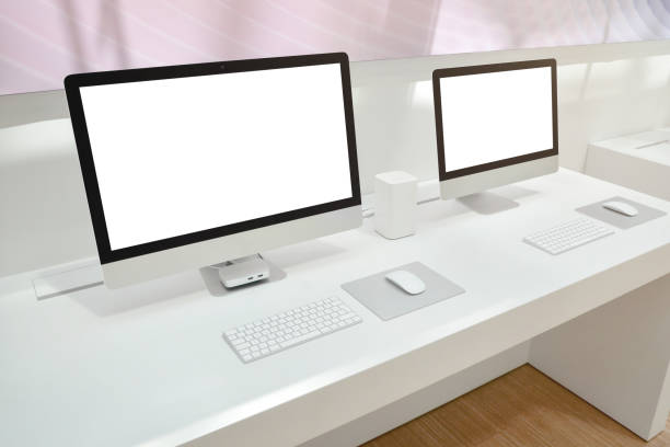 istock Two computers with isolated screens for mockup on office desk. 1154348374