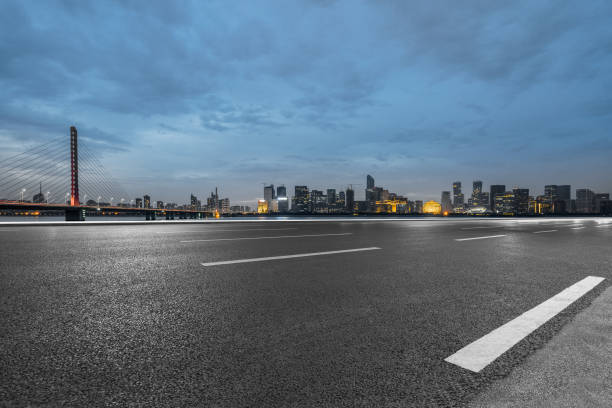 istock Empty asphalt road through modern city at dusk, China 1154348401