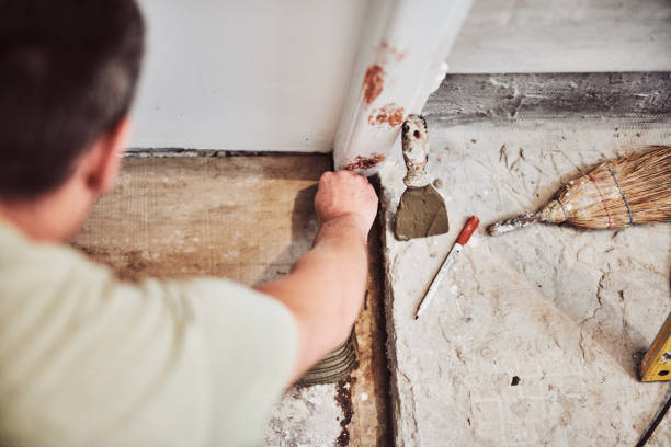 istock Leveling ceramic tiles on a floor. Shallow depth of field. 1154351428