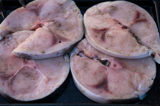 Big pieces of fresh tuna fish in a baking tray ready for grill.